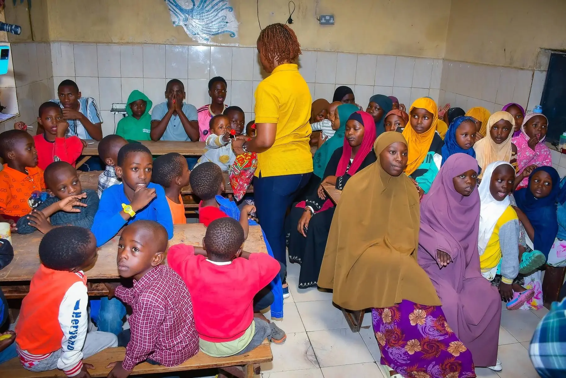 Children and adults taking part in a group activity indoors