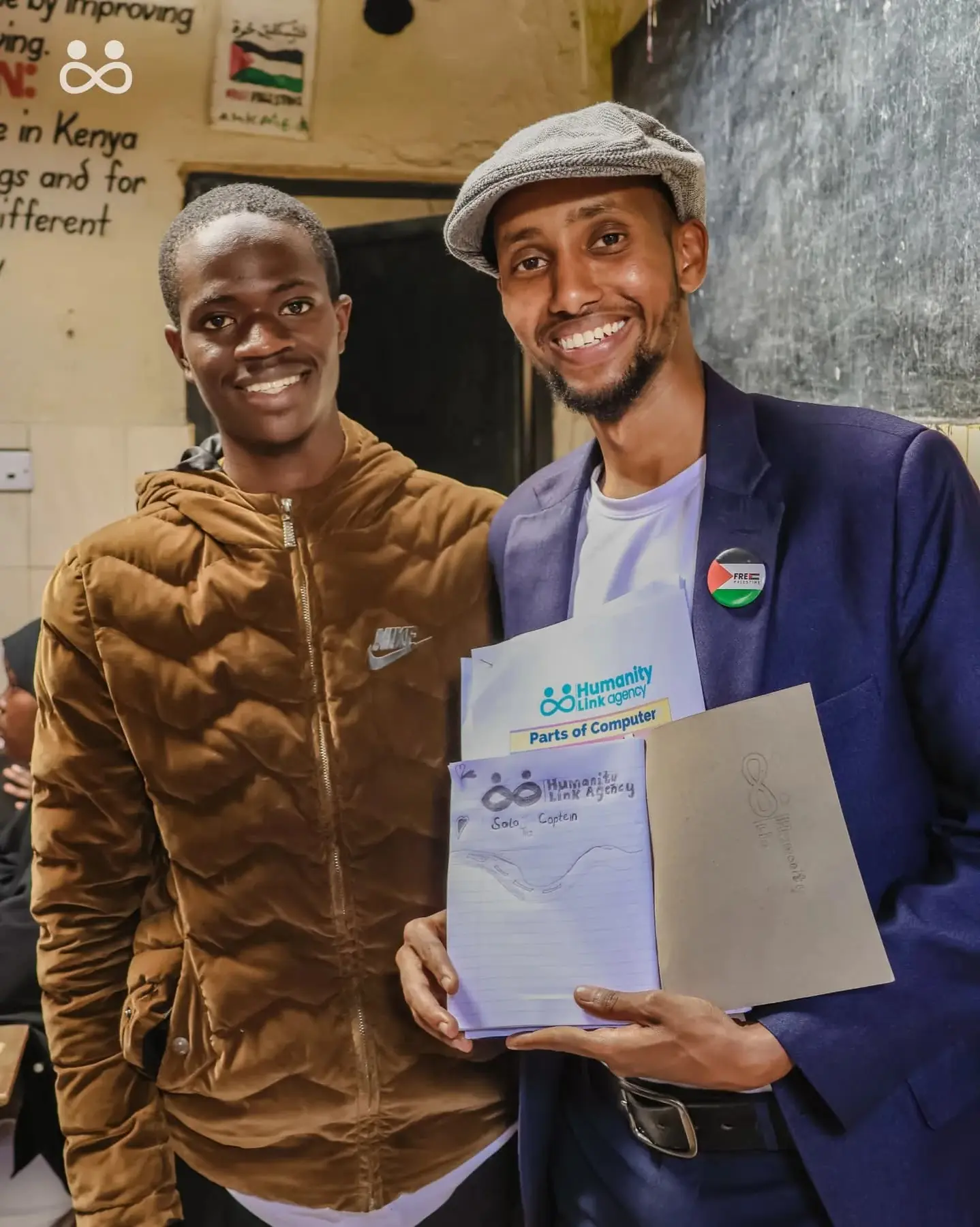 Two adults holding a certificate at an event