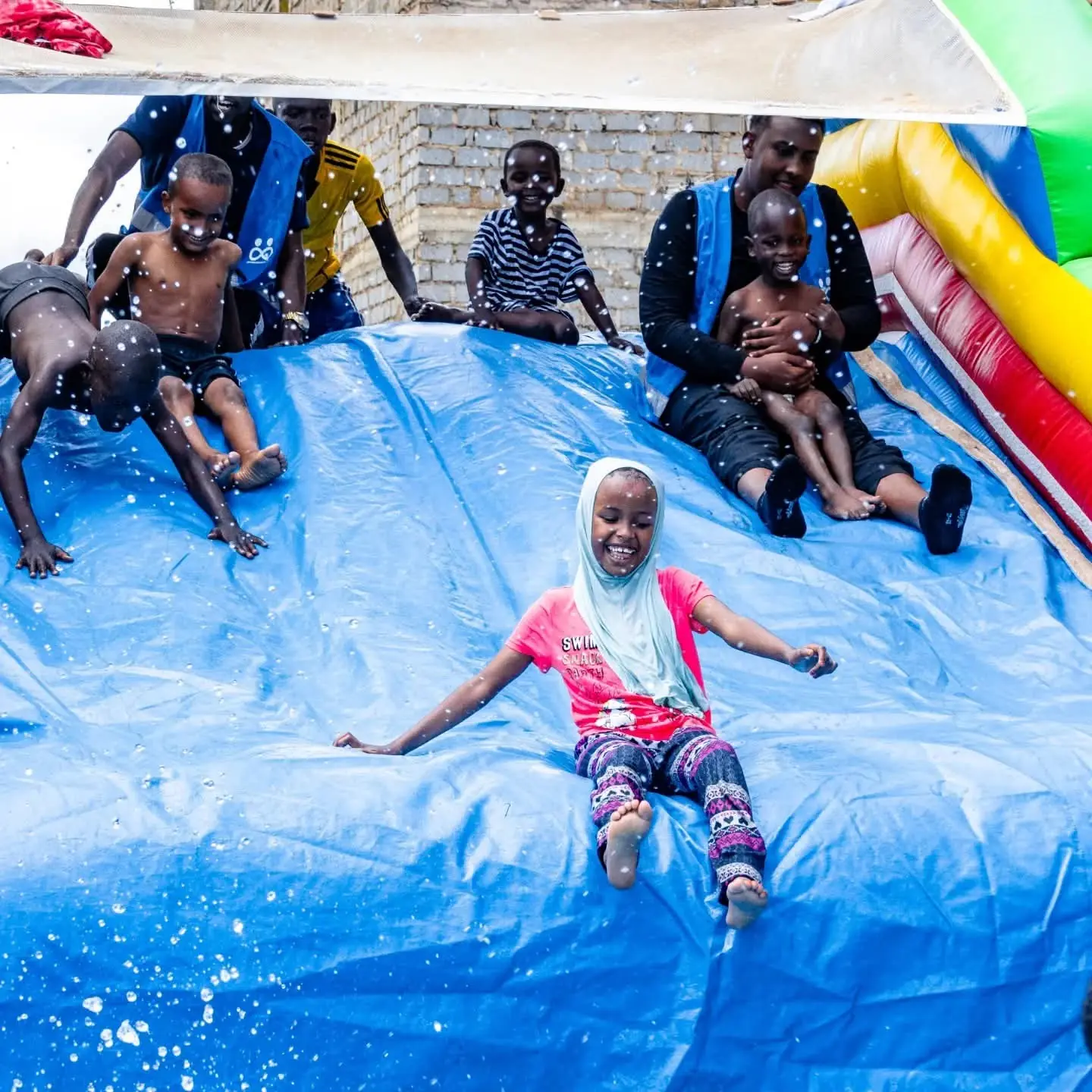 Children playing together in an outdoor pool